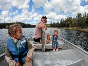 Family fishing trip on a lake with children enjoying the outdoors