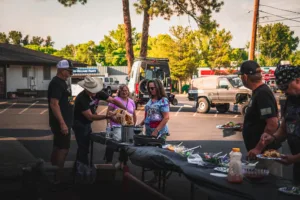 Summit 4X4 community event cookout with members serving food outdoors