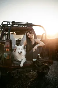 Woman and dog sitting on off-road vehicle customized by SUMMIT 4X4 COMPANY
