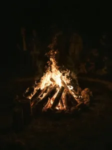 Campfire gathering at night with SUMMIT 4X4 COMPANY outdoor adventure