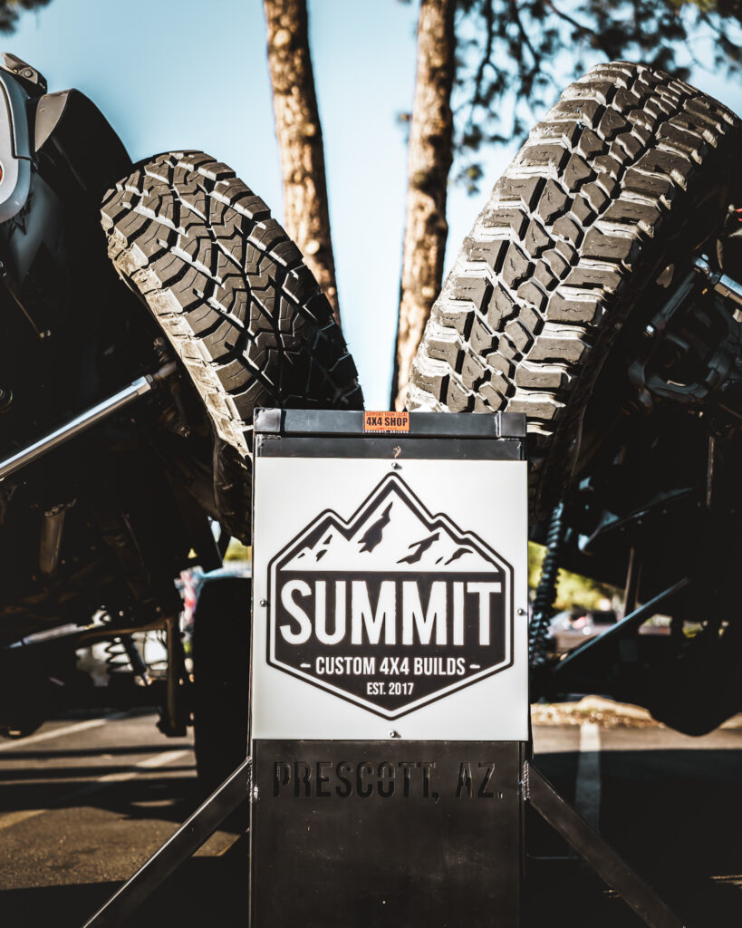 summit 4x4 Company custom builds sign with off-road tires display in Prescott AZ