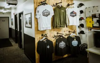 SUMMIT 4X4 COMPANY branded t-shirts, hoodies, and hats on display