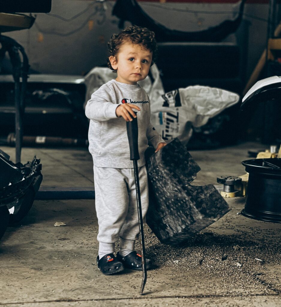 Kid helping parents work on cars